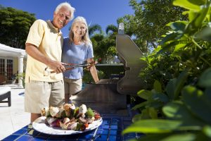 Happy couple enjoying their tree-filled garden in summer